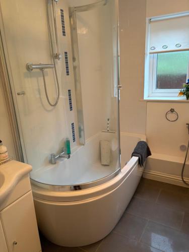 a bathroom with a bath tub and a shower at Hillhouse in Hythe