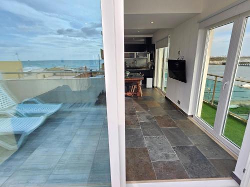 a room with a balcony with a view of the ocean at Blife Charlya private rooms at Faro beach in FAO