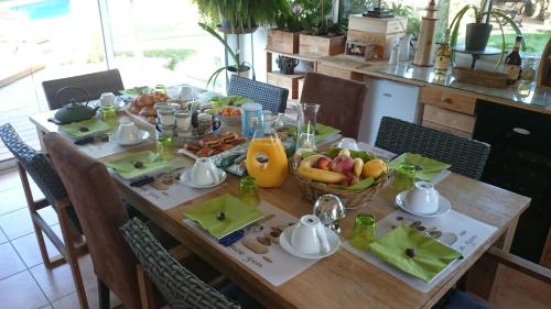 a table with a bunch of food on it at Le Clos des Romarins in Saint-Palais-sur-Mer
