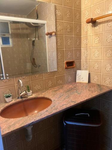 a bathroom with a sink and a mirror at Casa do Sal in São Luís