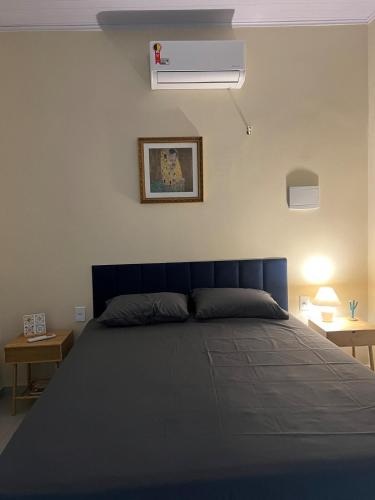 a bedroom with a blue bed and a air conditioner at Casa do Sal in São Luís