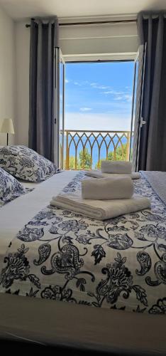 a bedroom with a bed with a view of the ocean at Inas Place in Baška Voda