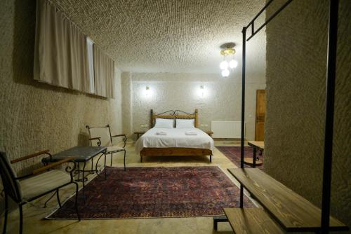 a bedroom with a bed and a mirror at Nirvana Cave House in Avcılar