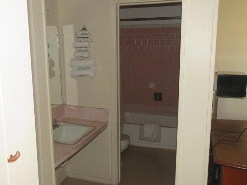 a bathroom with a sink and a toilet at Economy Inn in Socorro