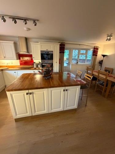 a kitchen with a large island in the middle at Hillhouse in Hythe