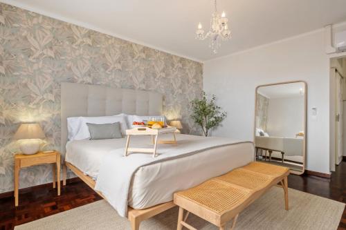 a bedroom with a large bed and a mirror at Villa Amor Do Mar -180° Sea View, Jacuzzi,Terrace in Funchal