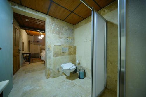 a bathroom with a toilet and a sink in it at Nirvana Cave House in Avcılar