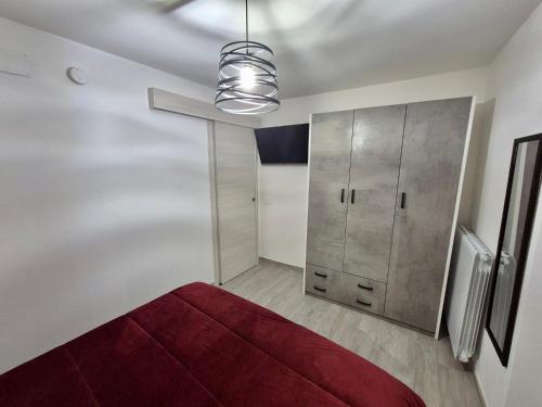 a bedroom with a red bed and a closet at Residenza Aurora in Isernia