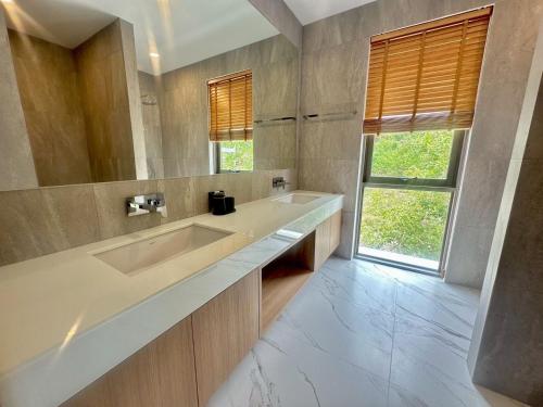 a bathroom with two sinks and a large window at Villa M3 De Samui in Nathon Bay