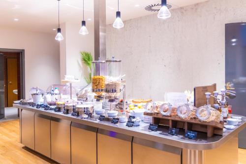a buffet of food on a counter in a room at LVG Hotel Collection - Gardenia in Verona