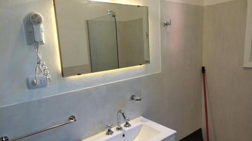 a bathroom with a sink and a mirror on the wall at Hotel Zapata in La Cumbre