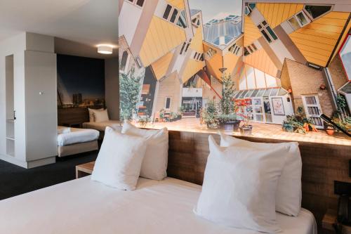 a hotel room with a bed with white pillows at Rotterdam Teleport Hotel in Rotterdam