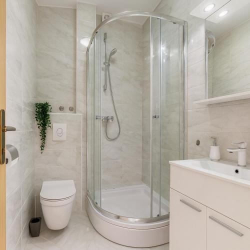 a bathroom with a shower and a toilet and a sink at Apartments Marija in Bibinje
