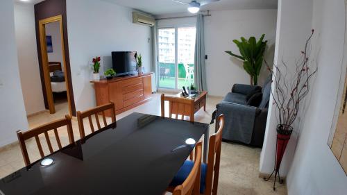 a living room with a black table and chairs at Apartalux Magic Paradise in Oropesa del Mar