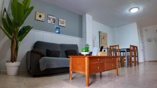 a living room with a couch and a table at Apartalux Magic Paradise in Oropesa del Mar