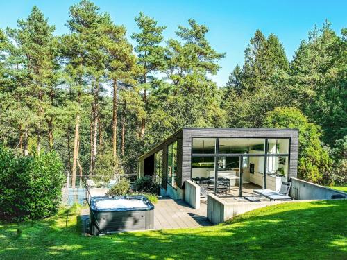 a small house with a deck and glass at 4 star holiday home in Ebeltoft in Ebeltoft