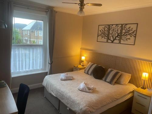 a bedroom with a bed with two towels on it at Hambledon Hotel in Shanklin