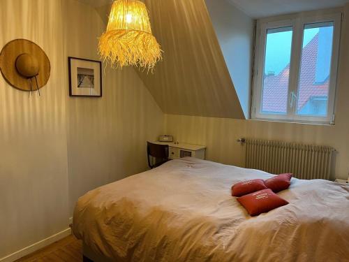 a bedroom with a bed and a chandelier at Reve dOpale in Étaples