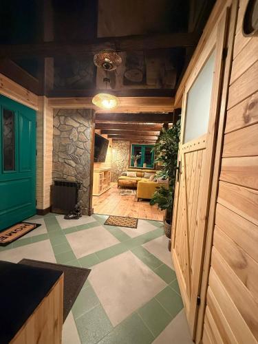 a room with a living room with a couch and a door at Leśna 6 in Sierakowo