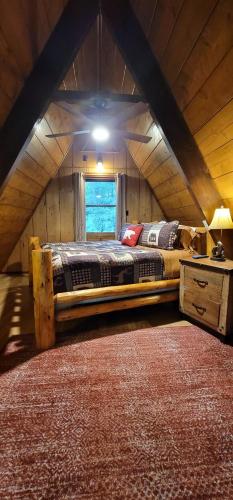 a bedroom with a large bed in a attic at Roaring Fork Chalet in Burnsville