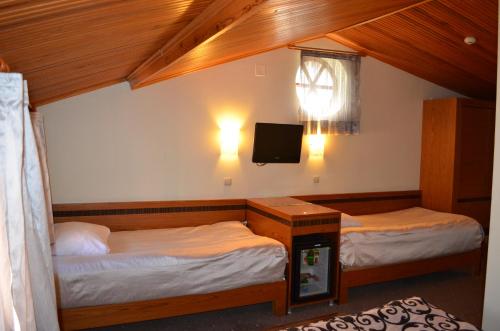 Postel nebo postele na pokoji v ubytování Atlas Otel