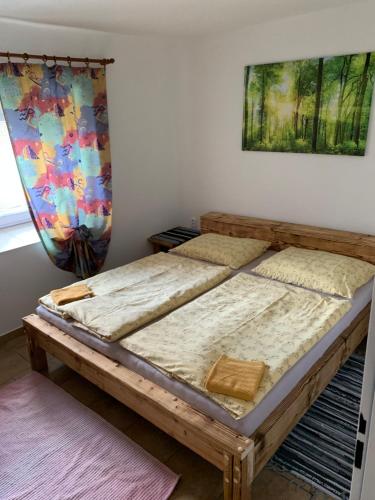 two beds in a room with a painting on the wall at Apartmans ZBYTINY 21 in Zbytiny