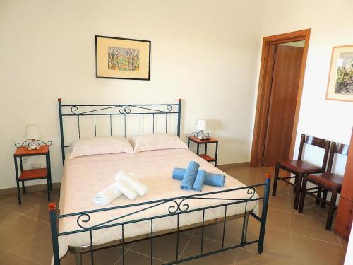a bedroom with a bed with towels on it at Casa Alicudi in Lipari