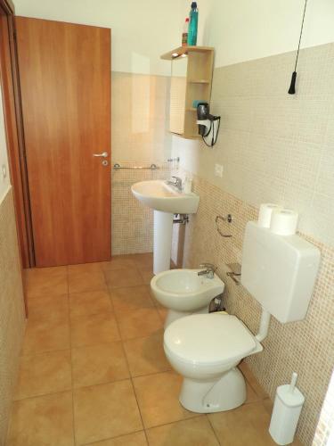 a bathroom with a toilet and a sink at Casa Alicudi in Lipari