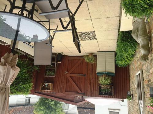a building with a wooden door and plants at Harpenden House in Harpenden