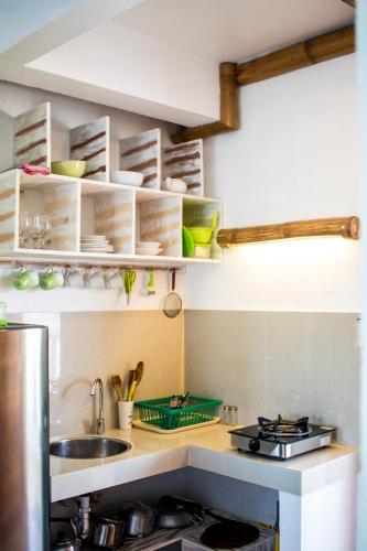 a kitchen with a sink and a counter top at Lanterna Hotel Boracay in Boracay