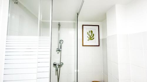 a shower with a glass door in a bathroom at La Parenthèse Urbaine - T2 Cosy et fonctionnel - Metro 5 Bobigny in Bobigny