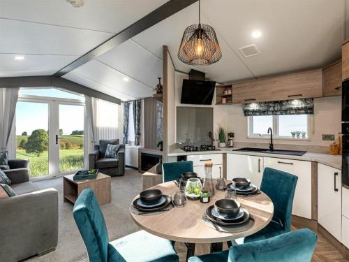 a kitchen and living room with a table and chairs at Jackson Lodge - Primrose in Malton