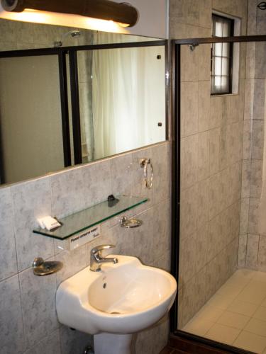 a bathroom with a sink and a shower at Lanterna Hotel Boracay in Boracay