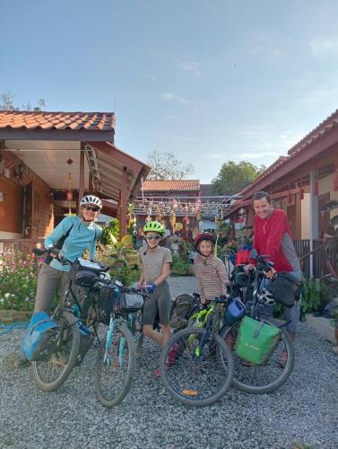 a group of people standing with their bikes at K Khan Chiang Khan Walking Street Garden Home in Chiang Khan