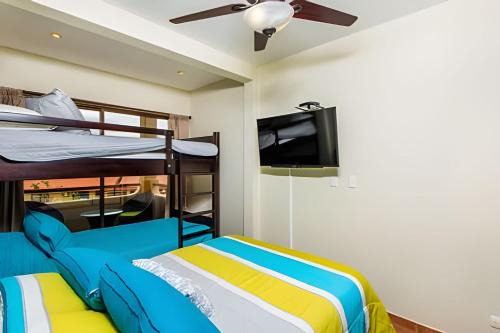 a bedroom with two bunk beds and a flat screen tv at Coco Sunset Hills 52 in Coco