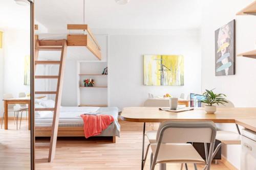 a room with a loft bed and a desk with a desk at Citykoti Downtown Studios in Helsinki
