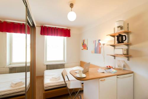 a small room with a desk and a bed at Citykoti Downtown Studios in Helsinki