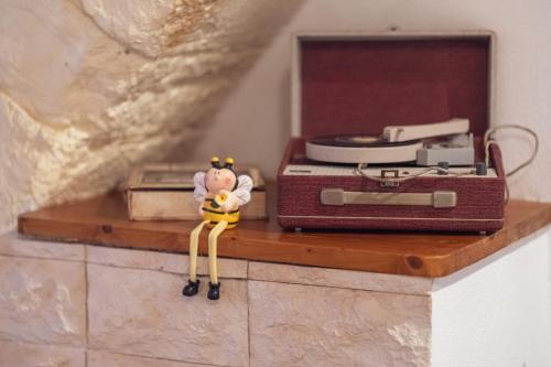 a toy figurine sitting on a shelf next to a suitcase at Sassari Station Inn in Sassari