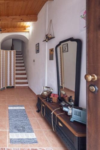 a mirror on a dresser in a room with a staircase at Sassari Station Inn in Sassari