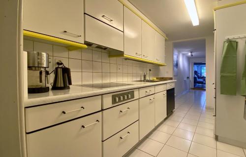 a kitchen with white cabinets and a counter top at Appartment floor 1 in Thun