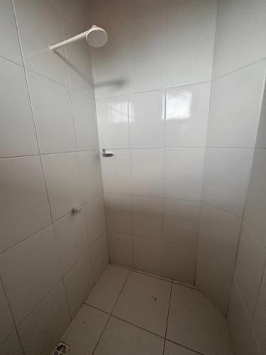 a bathroom with a shower with white walls at Casa Altos JM in Ananindeua