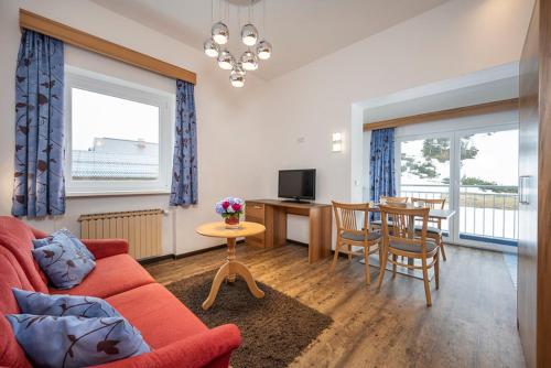 a living room with a couch and a table and a dining room at MIA Appartements - non-serviced Appartements in Obertauern