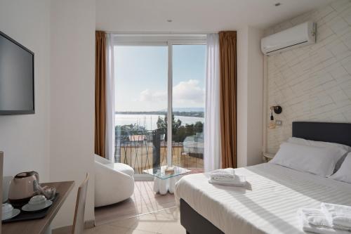 a hotel room with a bed and a large window at Hotel Centrale in Syracuse