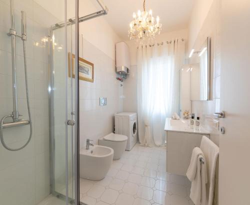 a bathroom with a toilet and a sink and a shower at Lizard Residence in Lido di Jesolo