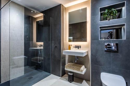 a bathroom with two sinks and a shower at Arran Shores Luxury Shorefront Penthouse Suite 10 in Lamlash