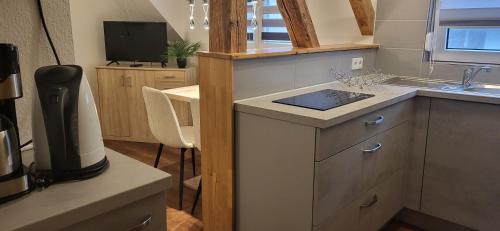 a kitchen with a sink and a counter top at Ferienwohnung Jasmin in Rust
