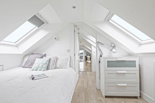 a bedroom with skylights and a bed in a room at The Loft modern flat in the heart of Wadebridge in Wadebridge