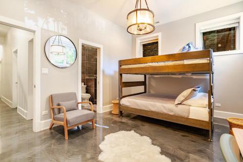 a bedroom with a bunk bed and a chair at Hello Again, Chicago! in Chicago