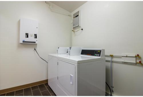 a kitchen with a white refrigerator and a microwave at Motel 6 Kerrobert, SK in Kerrobert