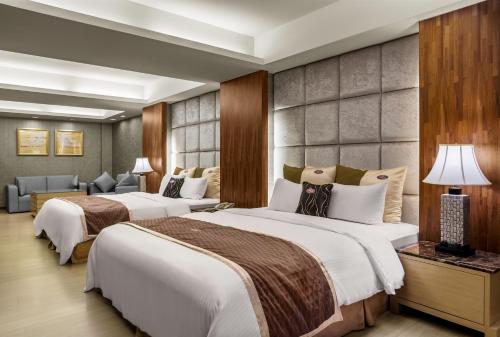 เตียงในห้องที่ Chuang-Tang Spring SPA Hotel - Deyang